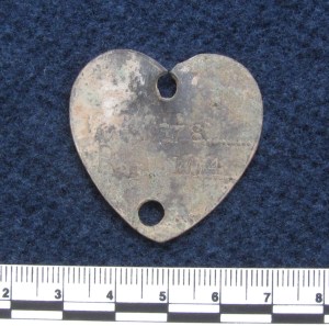 Heart-shaped dog tag stamped with registration 104 and district 78