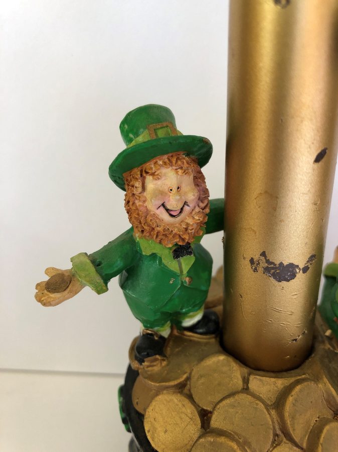 Leprechaun standing on pot of gold