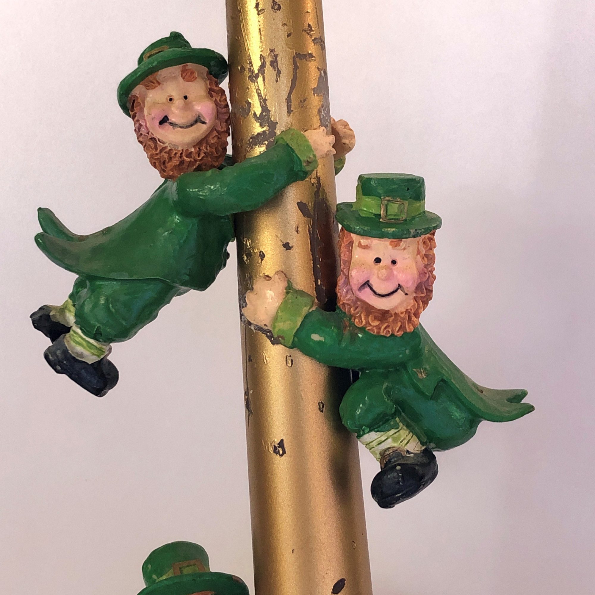 Leprechauns on a gold candle