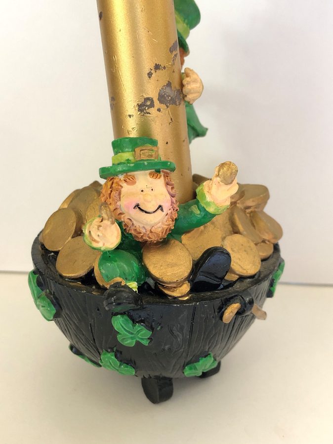 Leprechaun sitting on pot of gold